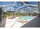 Screened pool with adjacent spa and poolside seating at 14124 Kewanee Ln, Port Charlotte, FL 33981