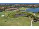 Aerial view of golf course, ponds and red-tile roofed buildings on a sunny day at 162 Palazzo Ct, North Venice, FL 34275
