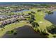 An aerial view of the home, golf course, and lake at 162 Palazzo Ct, North Venice, FL 34275