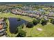 Beautiful aerial view of homes surrounding a golf course, a lake, and mature Florida landscaping at 162 Palazzo Ct, North Venice, FL 34275