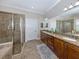 Primary bathroom has double sink vanity, tile flooring, granite counter tops, and a walk-in shower at 162 Palazzo Ct, North Venice, FL 34275