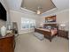 Elegant primary bedroom features trey ceiling, neutral walls, bench, and plenty of natural light at 162 Palazzo Ct, North Venice, FL 34275