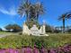 Entrance to Venetian Golf and River Club, featuring water fountain, mature landscaping, and lion statues at 162 Palazzo Ct, North Venice, FL 34275