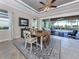 Elegant dining room with stylish furnishings, a ceiling fan, and sliding doors leading to the outdoor patio at 162 Palazzo Ct, North Venice, FL 34275