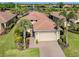 Beautiful home featuring a well-manicured lawn, tile roof, and a two-car garage, close to a scenic lake at 162 Palazzo Ct, North Venice, FL 34275