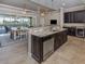 Gourmet kitchen featuring stainless steel appliances, granite countertops, and island with seating at 162 Palazzo Ct, North Venice, FL 34275