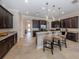 Open kitchen featuring stainless steel appliances, granite countertops, and a breakfast bar at 162 Palazzo Ct, North Venice, FL 34275