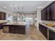 Spacious kitchen with granite countertops, stainless steel appliances, and an open view into the living room at 162 Palazzo Ct, North Venice, FL 34275