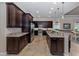 Chef's kitchen features stainless steel appliances, granite countertops, and ample cabinet space at 162 Palazzo Ct, North Venice, FL 34275