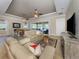 Cozy living room with comfortable seating, ceiling fan, and sliding doors to the outdoor living space at 162 Palazzo Ct, North Venice, FL 34275