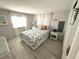Comfortable bedroom with white walls, light colored wood floors, and a queen bed with tropical themed bedding at 175 Palm Harbor Dr, North Port, FL 34287