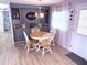 Cozy dining area with a wooden table, four chairs, built-in shelving, and natural light creates an inviting space at 175 Palm Harbor Dr, North Port, FL 34287