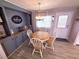Charming dining area with a round wooden table, decorative accents, and built-in storage, ideal for Gathering meals at 175 Palm Harbor Dr, North Port, FL 34287
