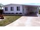 Inviting home with manicured lawn, brick accents, and a covered carport for convenient parking at 175 Palm Harbor Dr, North Port, FL 34287
