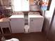 Practical laundry room with washer, dryer, and utility sink, offering convenience at 175 Palm Harbor Dr, North Port, FL 34287