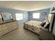 Serene main bedroom with blue walls, plush bedding, and stylish furnishings creates a restful retreat at 175 Palm Harbor Dr, North Port, FL 34287
