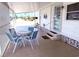 Relaxing covered patio features comfortable seating, perfect for enjoying the outdoors at 175 Palm Harbor Dr, North Port, FL 34287