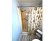 Bathroom shower with shower head and beach themed shower curtain, and assist bar at 175 Palm Harbor Dr, North Port, FL 34287