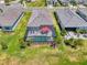 Aerial view of a home with a screened pool and patio, nicely landscaped, in a quiet neighborhood at 17515 Jadestone Ct, Venice, FL 34293