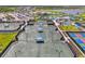 Overhead view of multiple tennis courts next to clubhouse, offering a vibrant community space for recreation and social gatherings at 17515 Jadestone Ct, Venice, FL 34293