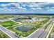 Aerial view of a baseball stadium with surrounding fields and ponds at 17515 Jadestone Ct, Venice, FL 34293