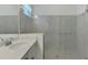 Bathroom featuring glass shower, white vanity with a single sink and bright lighting at 17515 Jadestone Ct, Venice, FL 34293