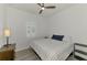 Bedroom featuring a window with plantation shutters and a striped bedspread at 17515 Jadestone Ct, Venice, FL 34293