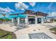 Inviting clubhouse with outdoor seating, a bar, and a casual dining area for residents to enjoy socializing at 17515 Jadestone Ct, Venice, FL 34293