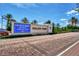 Scenic view of Wellen Park's entrance with palm trees, brick road, and the community signage at 17515 Jadestone Ct, Venice, FL 34293