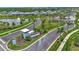 Aerial view of the Wellen Park entrance showcases elegant signage, lush landscaping, and access roads with nearby homes at 17515 Jadestone Ct, Venice, FL 34293