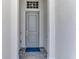 The home's front door features a covered entryway and a modern gray color at 17515 Jadestone Ct, Venice, FL 34293