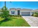 Well-maintained home features a two-car garage, paver driveway, and a beautifully landscaped yard at 17515 Jadestone Ct, Venice, FL 34293