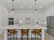 Stylish kitchen with a center island, bar seating, and sleek, white cabinetry at 17515 Jadestone Ct, Venice, FL 34293