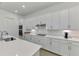 Modern kitchen featuring white cabinets, quartz countertops, and stainless steel appliances at 17515 Jadestone Ct, Venice, FL 34293