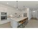 Modern kitchen features a large island with seating and state-of-the-art stainless steel appliances at 17515 Jadestone Ct, Venice, FL 34293