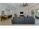 Spacious living area with a dining table, comfortable seating, and seamless indoor-outdoor flow at 17515 Jadestone Ct, Venice, FL 34293