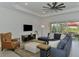 Inviting living room with a plush sectional, accent chair, and outdoor views at 17515 Jadestone Ct, Venice, FL 34293