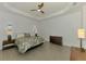 Spacious main bedroom features a tray ceiling and wood-look tile flooring at 17515 Jadestone Ct, Venice, FL 34293