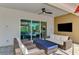 Covered outdoor seating area with a ceiling fan, and access to the lanai at 17515 Jadestone Ct, Venice, FL 34293
