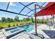 The screened-in lanai offers a pool, spa, and views of the surrounding landscape at 17515 Jadestone Ct, Venice, FL 34293