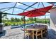 Screened lanai showcasing an outdoor kitchen, pool, and well-manicured landscaping at 17515 Jadestone Ct, Venice, FL 34293