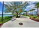 Picturesque walking path with a bench, lush greenery, and serene lake views at 17515 Jadestone Ct, Venice, FL 34293