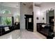A full bathroom with a large soaking tub and vanity offers a relaxing atmosphere with a garden view at 181 S Auburn Rd, Venice, FL 34292