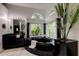This bathroom features a large black bathtub and a window that looks out onto lush greenery at 181 S Auburn Rd, Venice, FL 34292