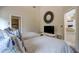 The bedroom has twin beds with neutral linens, a TV, and a walk-in shower in the en-suite bathroom at 181 S Auburn Rd, Venice, FL 34292