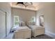 This sunny bedroom has two twin beds, a high ceiling, and an en-suite bathroom at 181 S Auburn Rd, Venice, FL 34292