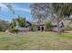 A charming residence featuring a well-manicured lawn and vibrant tropical landscaping at 181 S Auburn Rd, Venice, FL 34292
