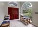 Elegant foyer with tile flooring, comfortable bench seating and bright natural light at 181 S Auburn Rd, Venice, FL 34292
