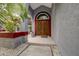 Ornate wooden double front doors with arched transom window, stylish and inviting entrance at 181 S Auburn Rd, Venice, FL 34292