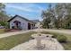 Beautiful house exterior with three-car garage, fountain, and lush landscaping at 181 S Auburn Rd, Venice, FL 34292